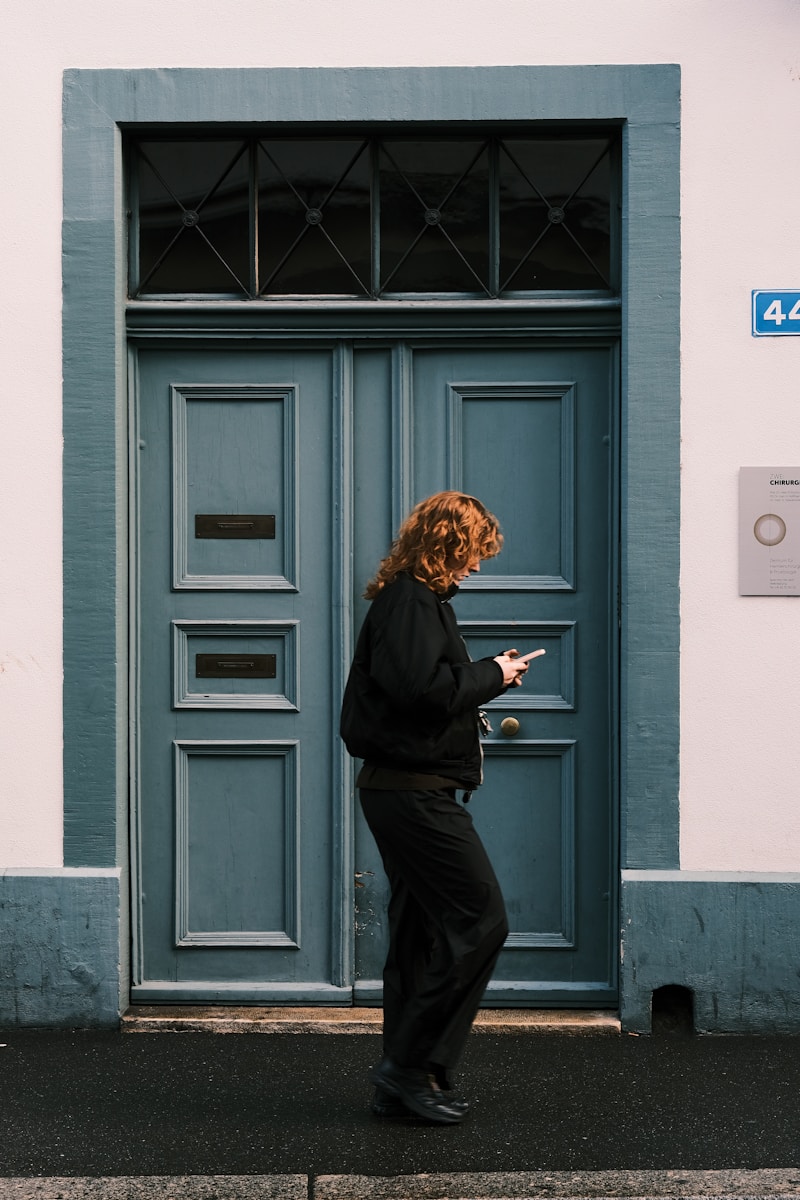 a woman standing in front of a blue door